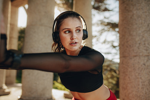 Fitness woman doing workout while listening to music