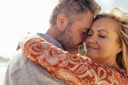 Affectionate senior couple together on beach