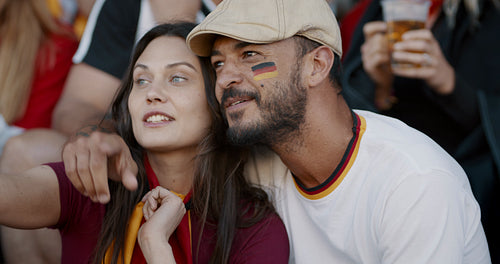German couple watching a sports event