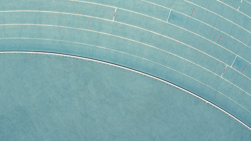 Proud athlete doing a victory lap with flag on racetrack