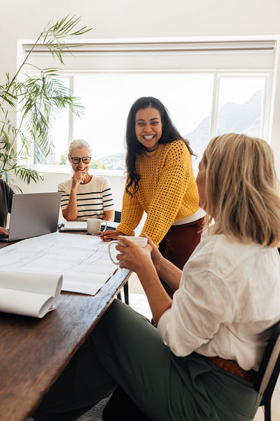 Architectural team brainstorming during meeting in modern office with natural light