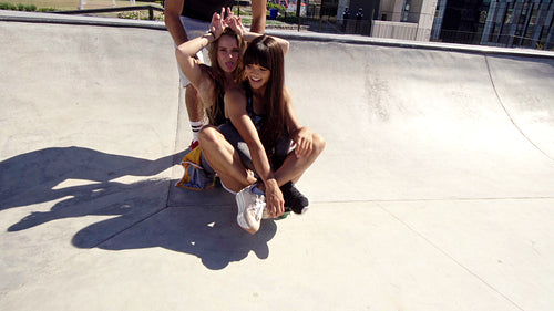 Group of happy friends having fun in a skate park