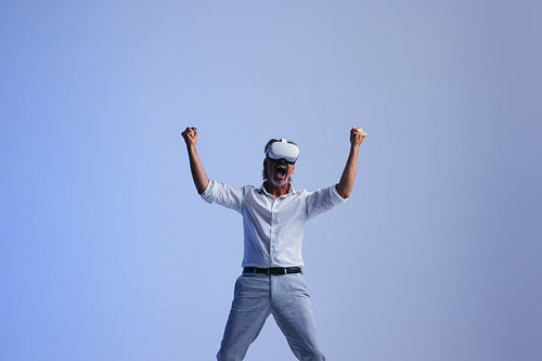 Businessman celebrating his success in the metaverse