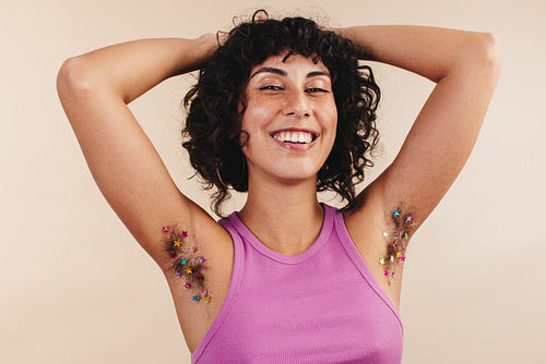 Body confident young woman flaunting her decorated arm pits
