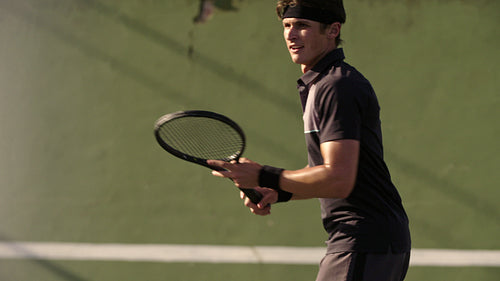 Tennis player practicing forehands strokes on court