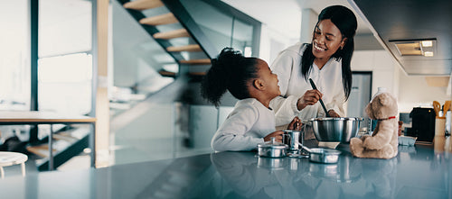 Mother and daughter spending time in the kitchen cooking