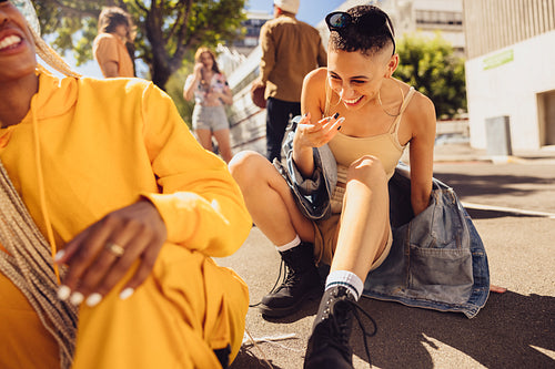 Female friends laughing together outdoors