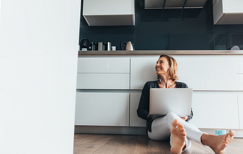Woman working on laptop computer at home