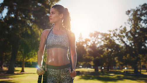 Determined young female with jumprope at the park