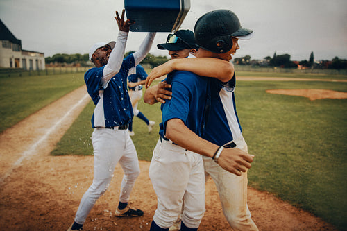 Baseball team celebrating victory with passion and joy on the field
