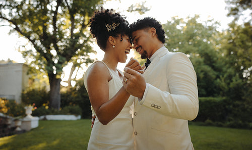 Romantic couple sharing a dance outdoors on their wedding day
