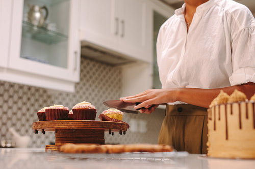 Confectioner cuts a homemade cupcake