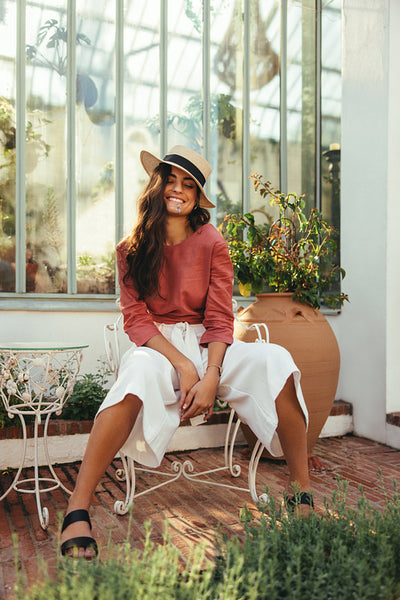 Smiling young tourist woman wearing a summer hat