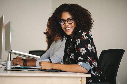 Smiling businesswoman working in office