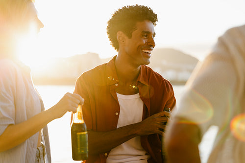 Friends enjoying drinks at sunset in summertime