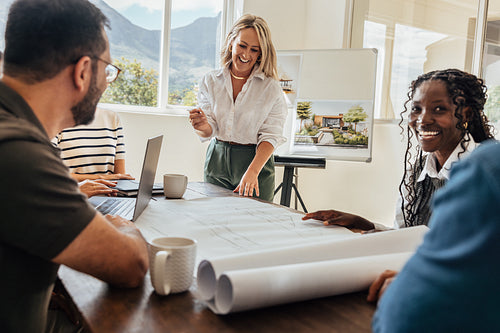 Team of architects discussing landscaping plans in a bright office setting