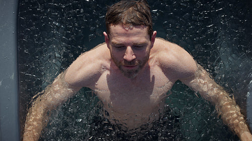 Man submerges into an outdoor ice bath with cold plunge focus for recovery