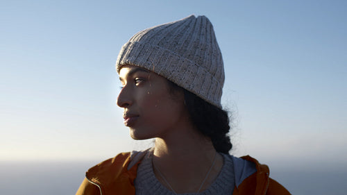 Woman standing outdoors on winter day looking around