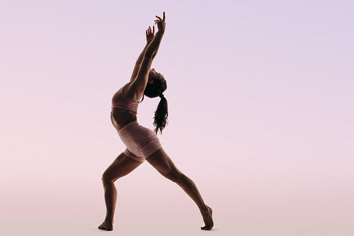 Athletic ballerina demonstrates artistic dance routine with flexibility and form