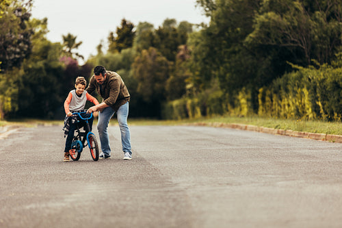 Kid learning to ride a bicycle