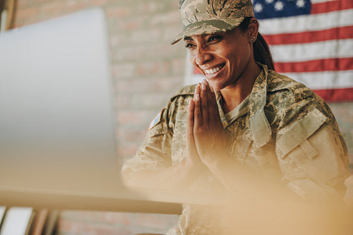 Cheerful servicewoman video chatting with her family