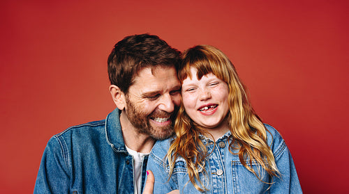 Joyful family moment as father and daughter laugh together