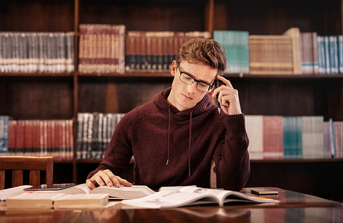 Young student preparing for exam in library