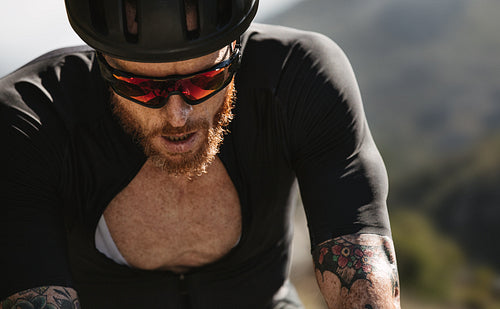 Professional cyclist looking exhausted