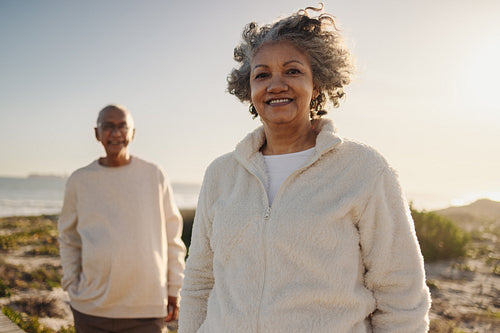Elderly woman smiling at the camera at the beach