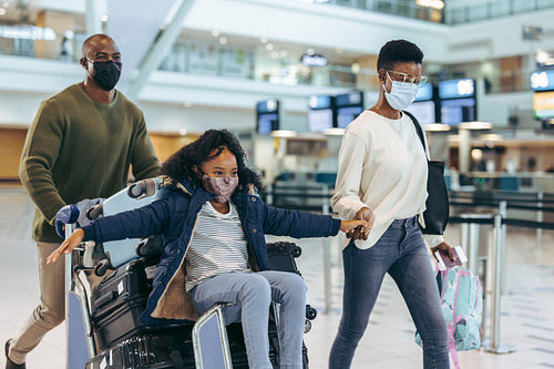 Family travelling during pandemic at airport