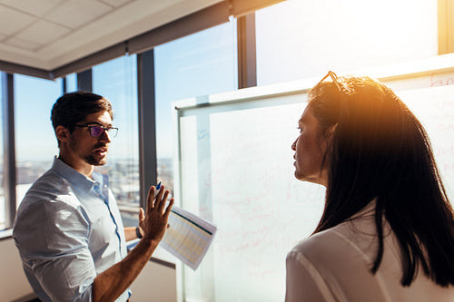 Entrepreneurs in office discussing business ideas.
