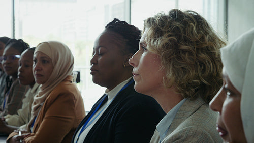 Businesswomen listening in corporate meeting