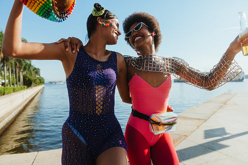 Two friends celebrate Brazilian carnaval by the water