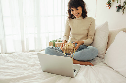 Woman showing christmas presents on video call