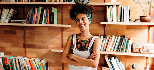 Young academic smiling in the library