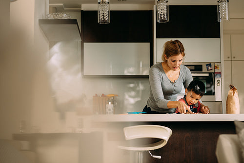 Mother teaching her son to make cookies