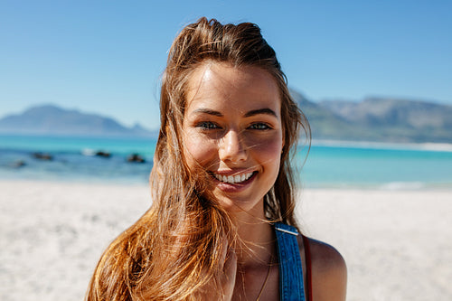 Beautiful woman with fluttering hair on the beach
