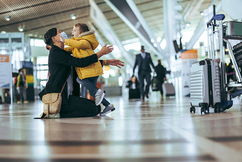 Woman welcomed by son at airport