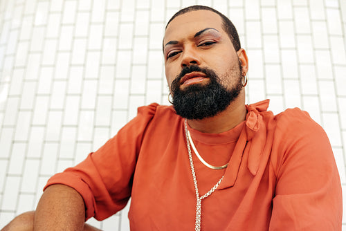Young man looking at the camera while wearing drag