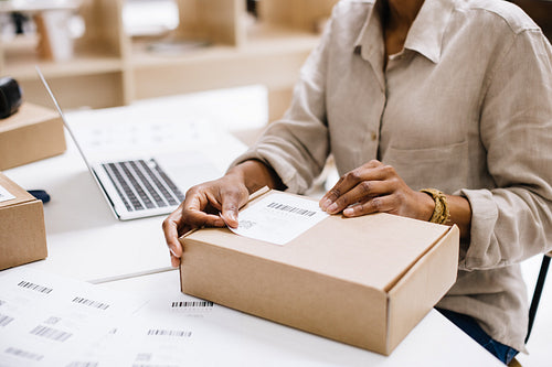Unrecognizable woman preparing an online order for shipping