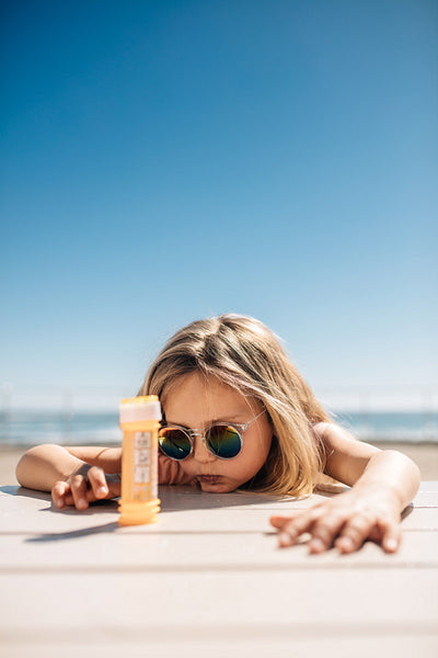 Cute girl playing with a toy on seaside  boardwalk