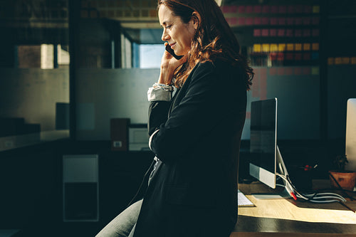 Woman entrepreneur on a phone call in office