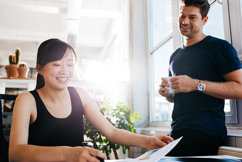 Happy young business partners working together at office