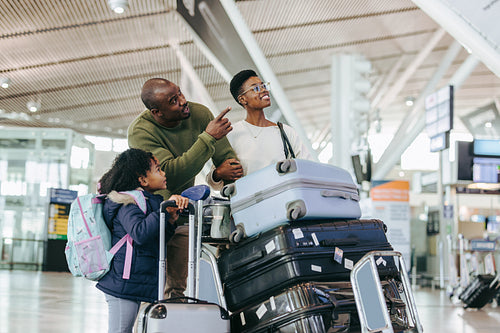 African family at airport standing with luggage