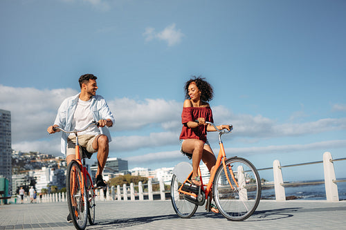 Tourist couple moving around the city on bicycles