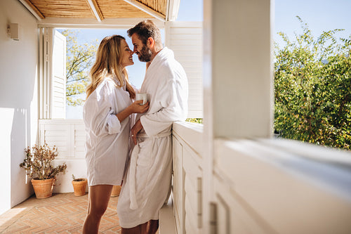 Romantic couple flirting on a balcony