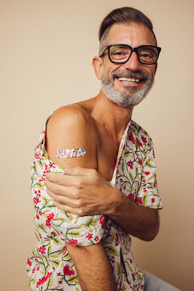 Mature man smiling after getting vaccine