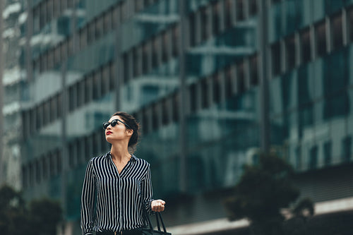 Young businesswoman walking outdoors