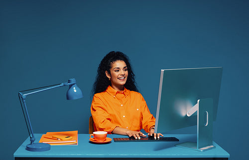 Female student working on a desktop computer with color blocking elements