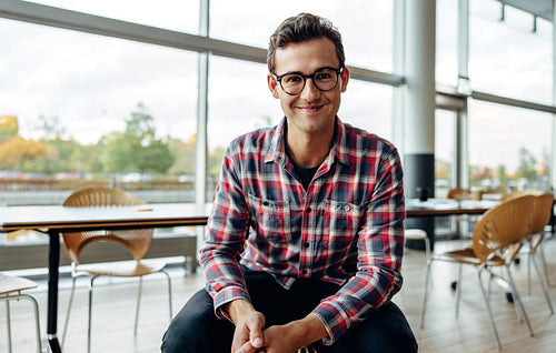 Positive businessman sitting in office
